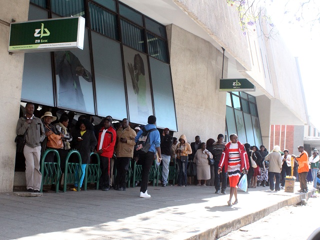 Clients queue for cash outside a Bulawayo bank yesterday