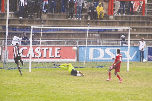 Highlanders striker Prince Dube (left) scores his team’s second goal, with ZPC Kariba’s goalie Tendai Hove diving in vain while defender  Sylvester Appiah  watches