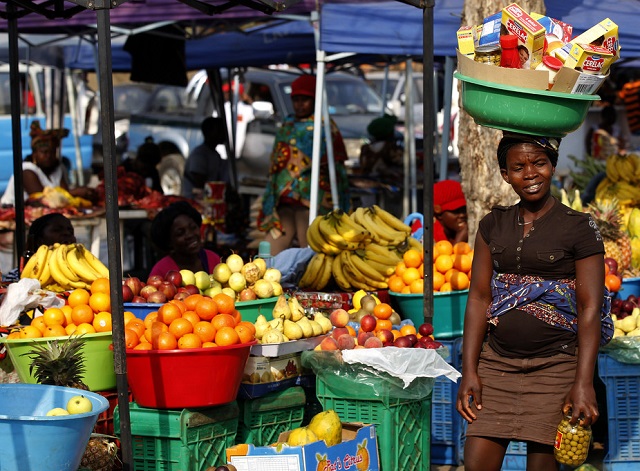 A woman walks through a market in Luanda, Angola. People who live in Africa’s cities rely heavily on the informal sector. — Reuters