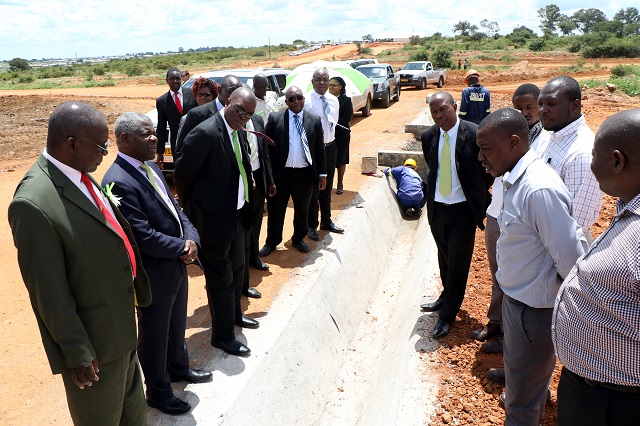 Old Mutual and CABS teams accompanied by the Bulawayo Mayor, Councillor Martin Moyo, (left) and council officials tour the CABS Pumula stands which are under servicing after a ground-breaking ceremony