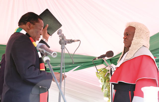 President Mnangagwa is sworn in by Chief Justice Luke Malaba at the National Sports Stadium in Harare yesterday. (Picture by Tawanda Mudimu)